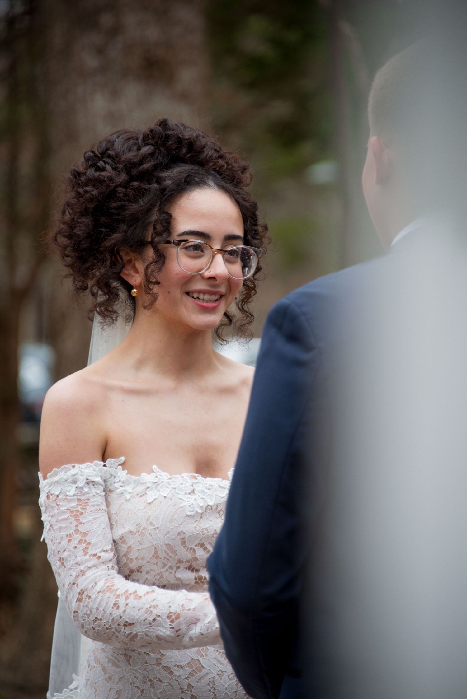Fried smiles at groom at the altar up close photo