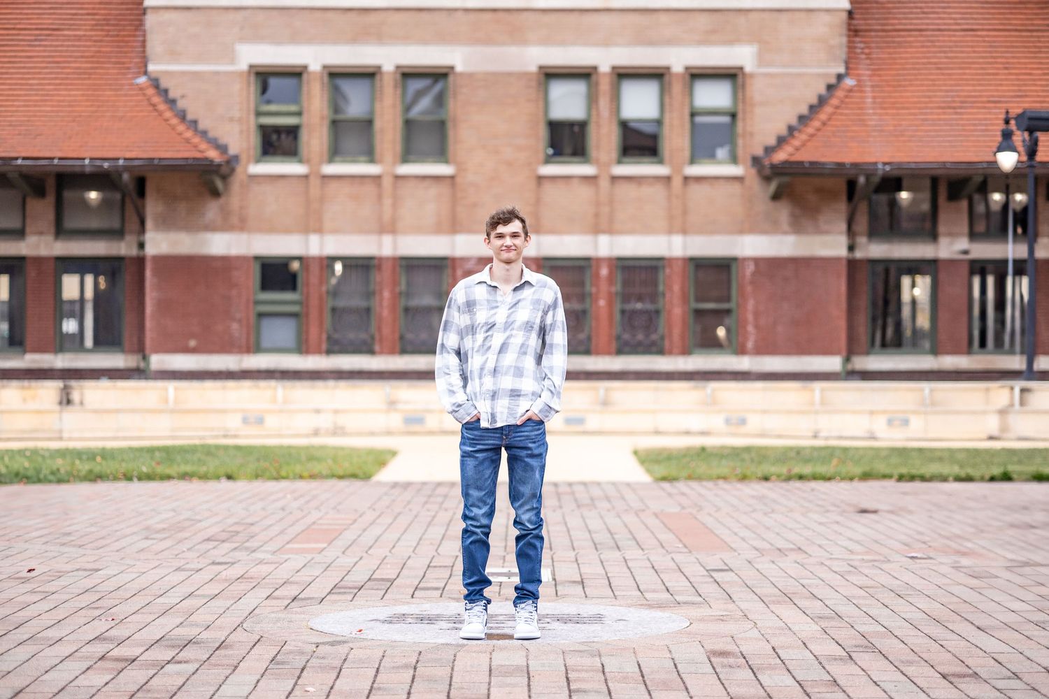 Springfield, IL senior photographer captures a senior standing on a brick pathway during a session in Central, IL