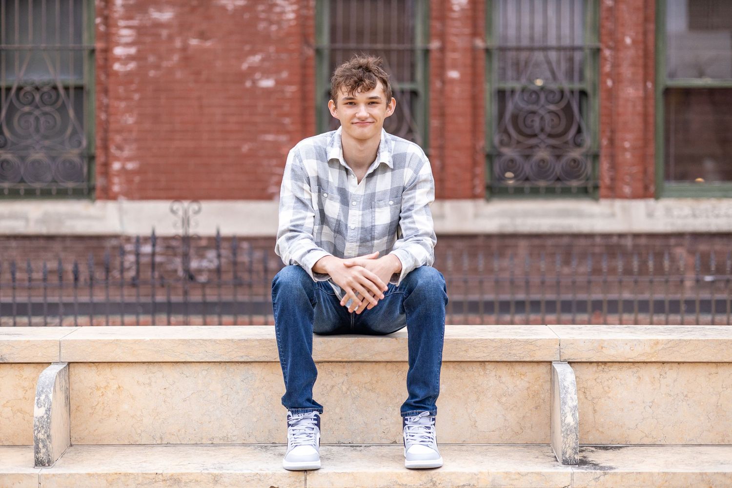 Springfield, IL senior photographer captures a senior sitting on steps during a session in Central, IL