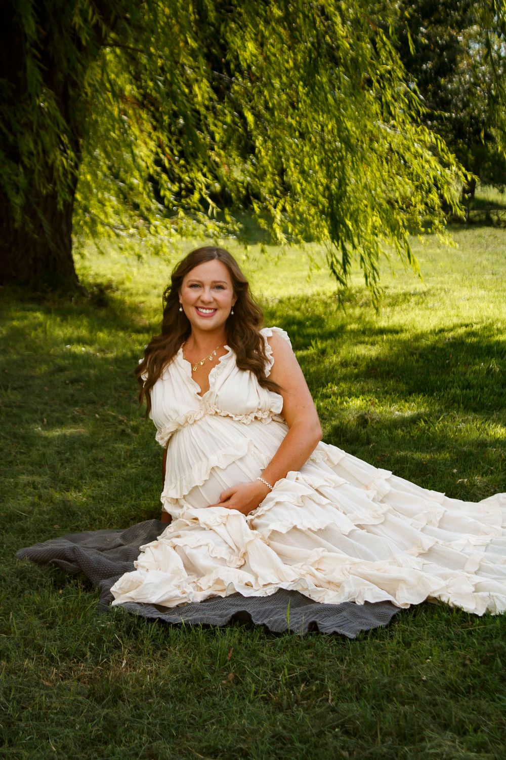 An expecting mother during a maternity photo session at Willow Tree Park in Canyon, Texas