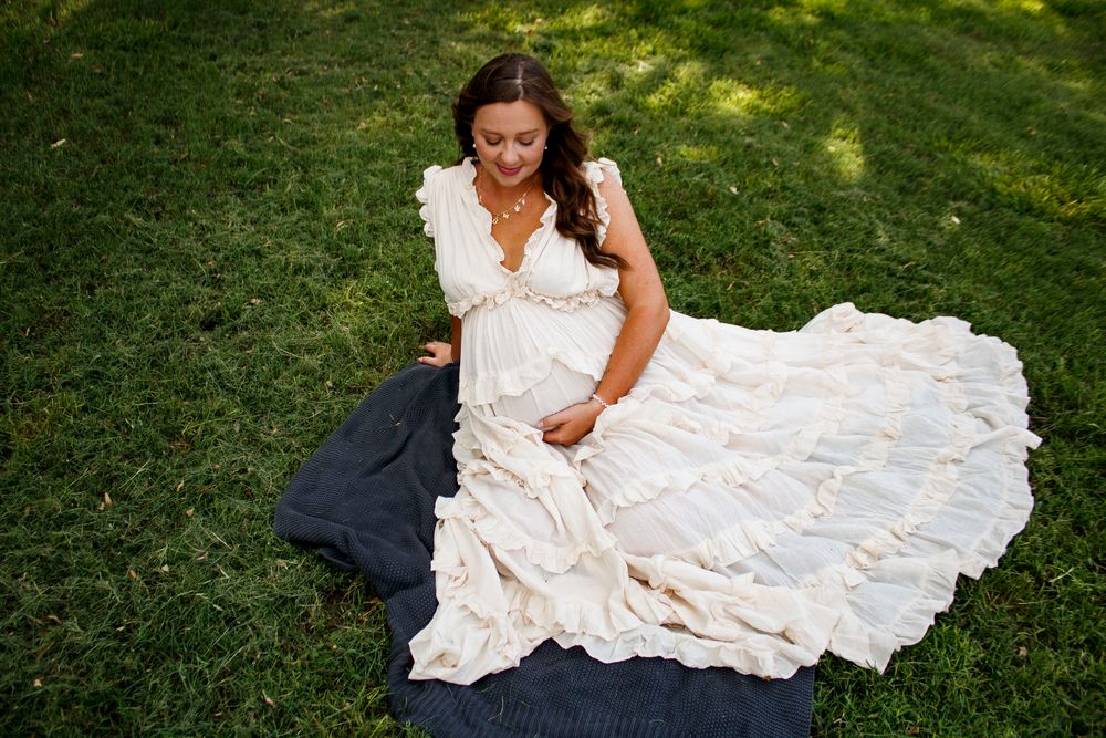 An expecting mother during a maternity photo session at Willow Tree Park in Canyon, Texas