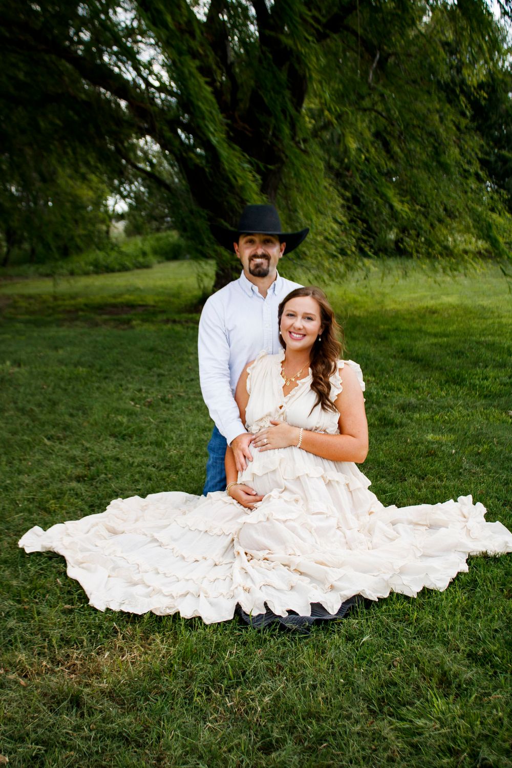 An expecting couple during a maternity photo session at Willow Tree Park in Canyon, Texas