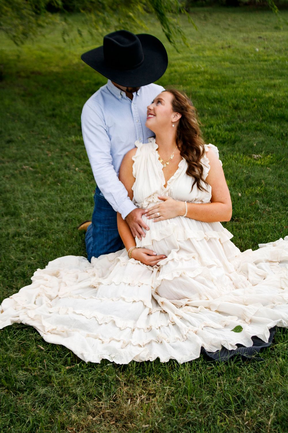 An expecting couple during a maternity photo session at Willow Tree Park in Canyon, Texas