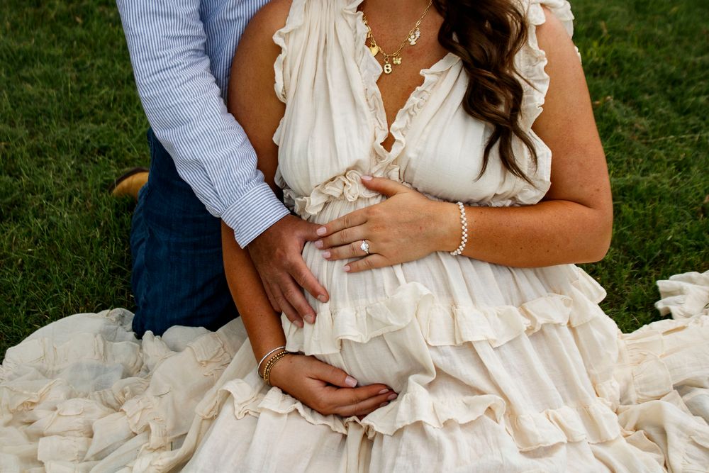 An expecting couple during a maternity photo session at Willow Tree Park in Canyon, Texas