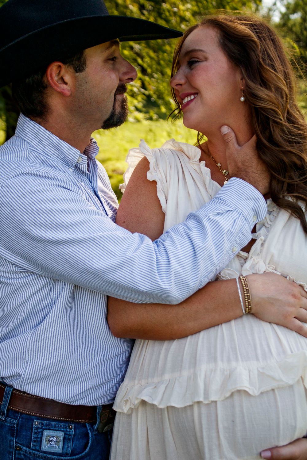An expecting couple during a maternity photo session at Willow Tree Park in Canyon, Texas