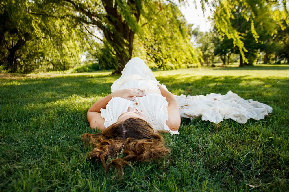 An expecting mother during a maternity photo session at Willow Tree Park in Canyon, Texas
