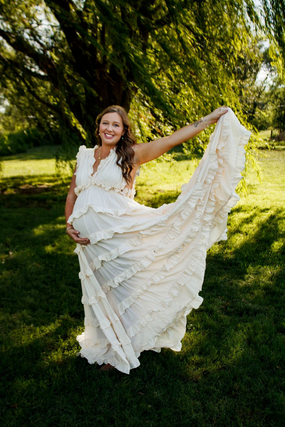 An expecting mother during a maternity photo session at Willow Tree Park in Canyon, Texas