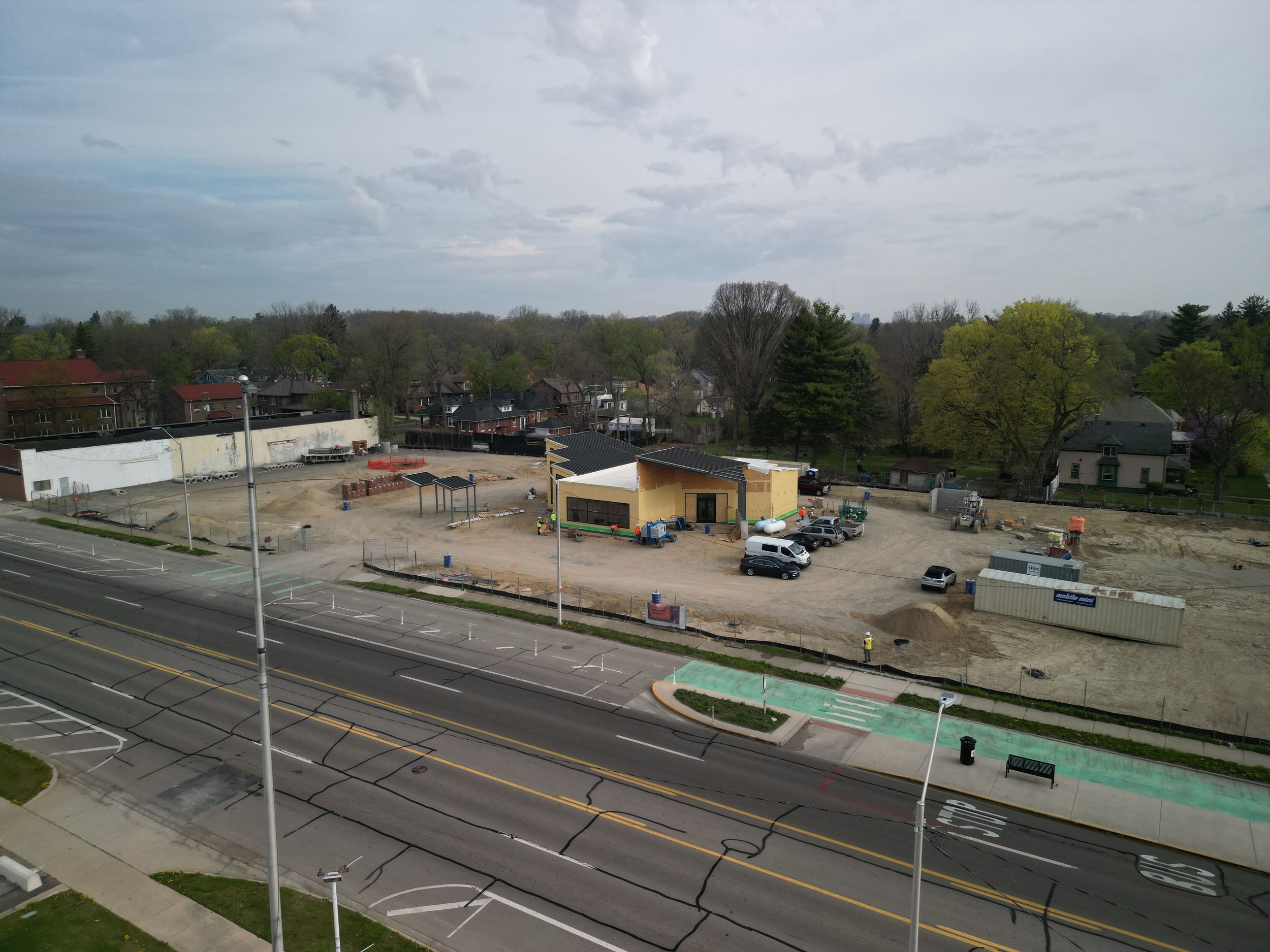 Drone view of Detroit construction site with equipment, progress tracking, and aerial mapping by Aerial Detroit.
