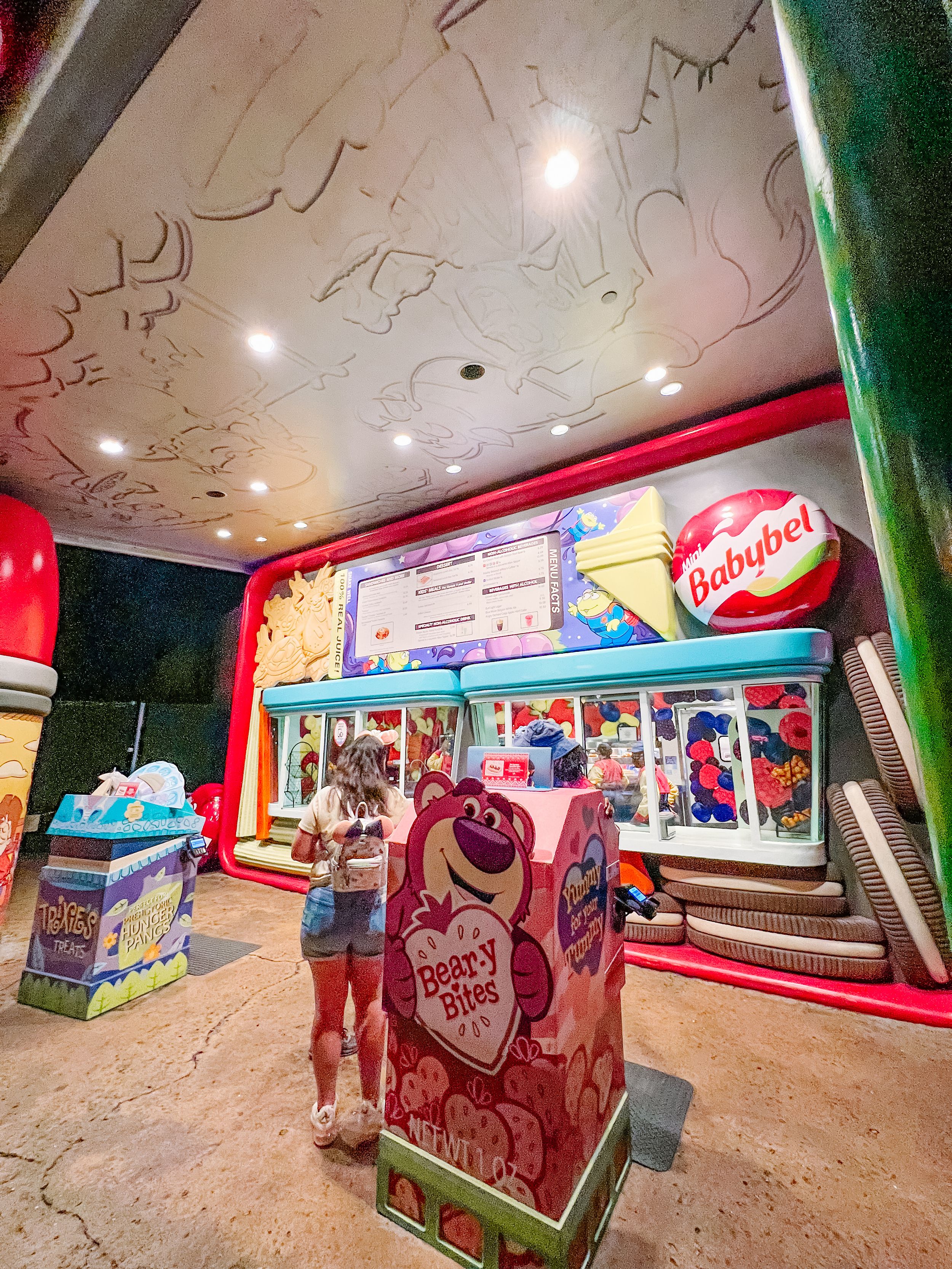 Retro-styled Babybel cheese themed retail space with bright colors and display counters.