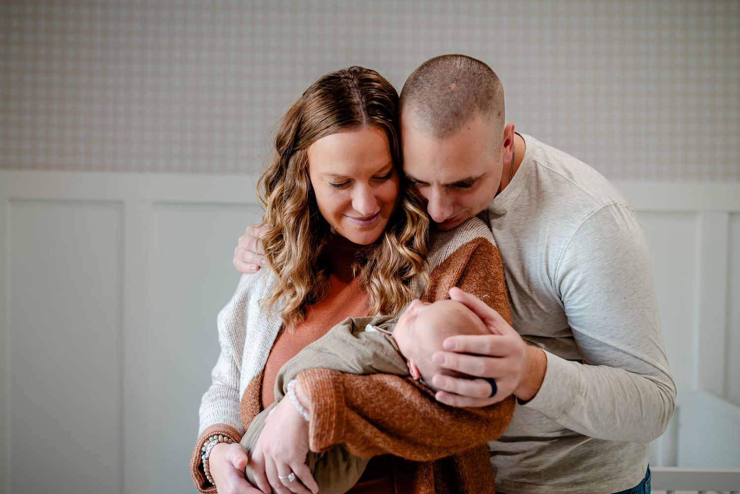 A couple shares intimate moments together during an indoor lifestyle photography session.