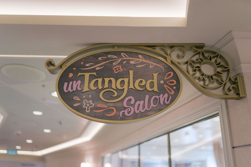 UnTangled Salon decorative sign with gold ornate frame inspired by Rapunzel at a Disney cruise ship.