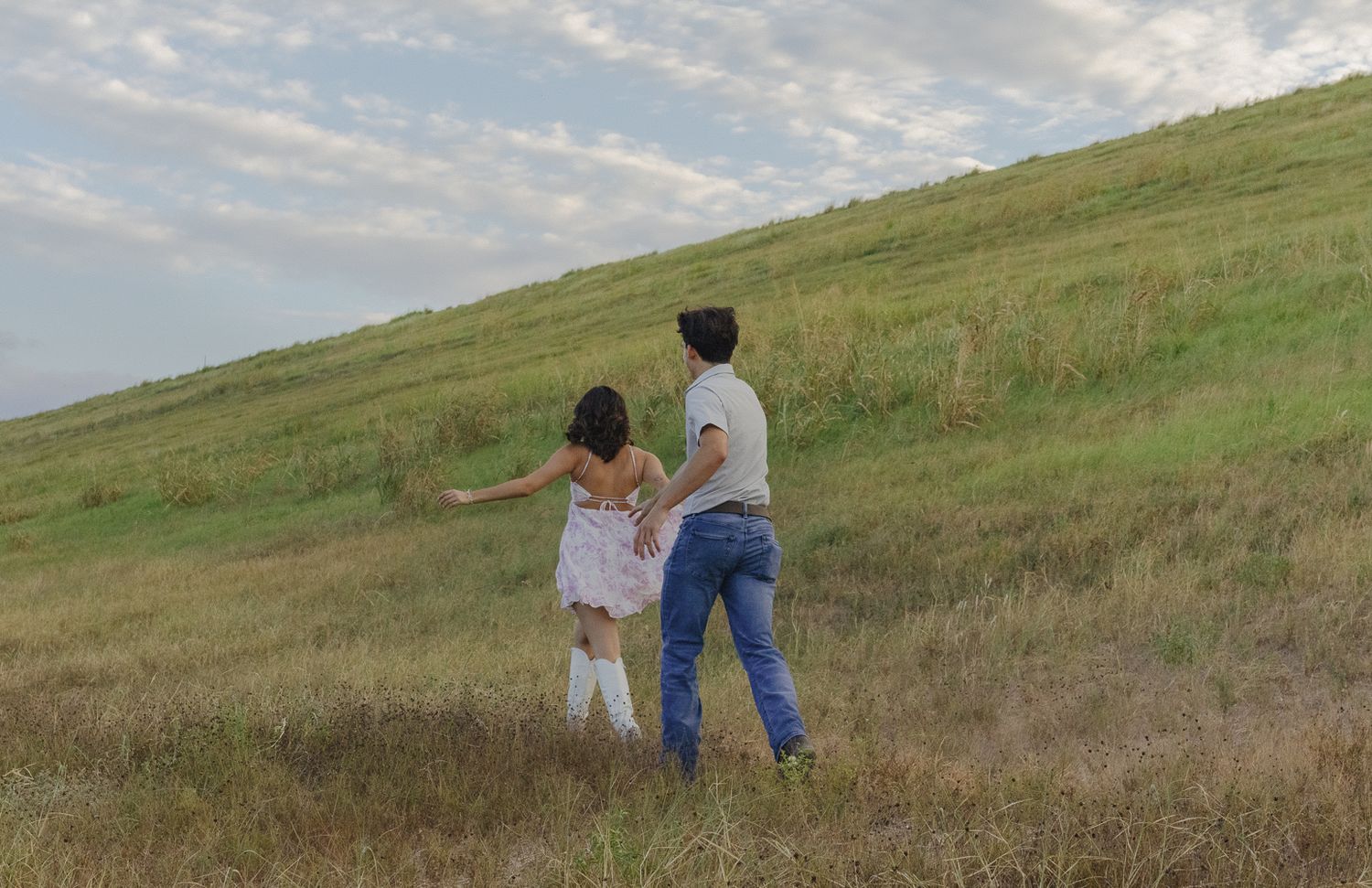 Romantic couple walking hand in hand on the hills of Canyon Lake.