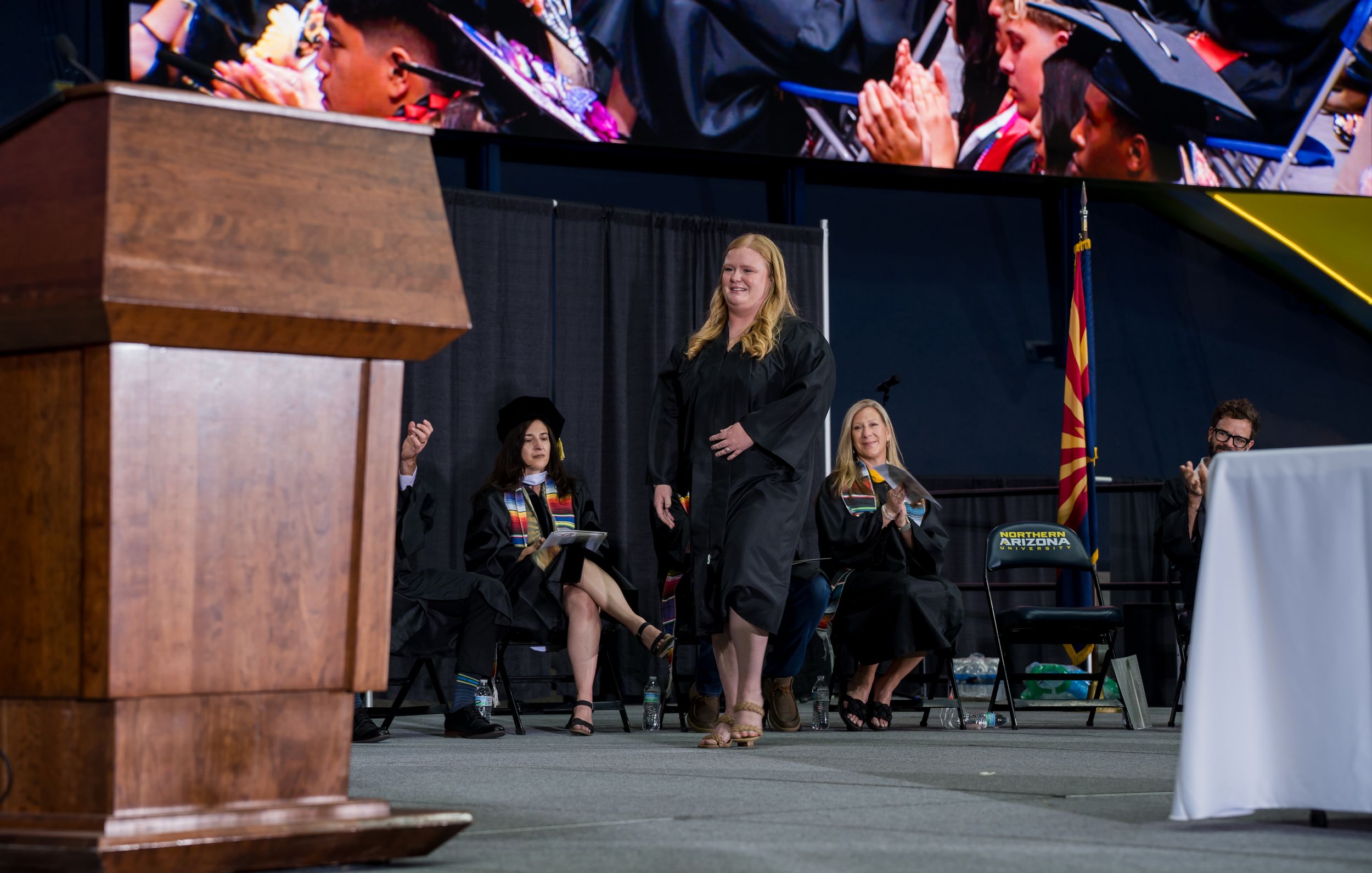 Kelly Marquez, the yearbook teacher, walks across the stage at the Walkup Skydome.
