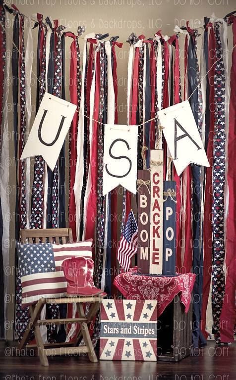 Patriotic USA banner with red, white, and blue ribbon backdrop, American flag pillow, cowboy boots, and Stars and Stripes decor.