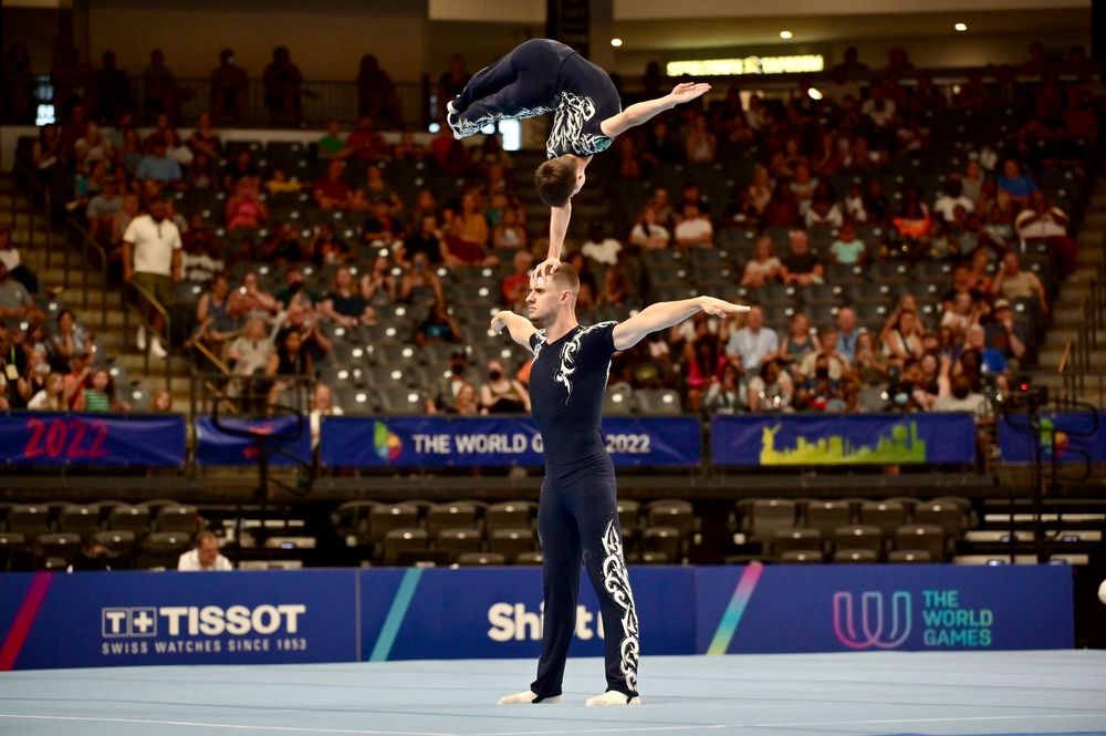 Two acrobatic gymnasts perform a balance routine at the 2022 World Games competition in Birmingham, Alabama.