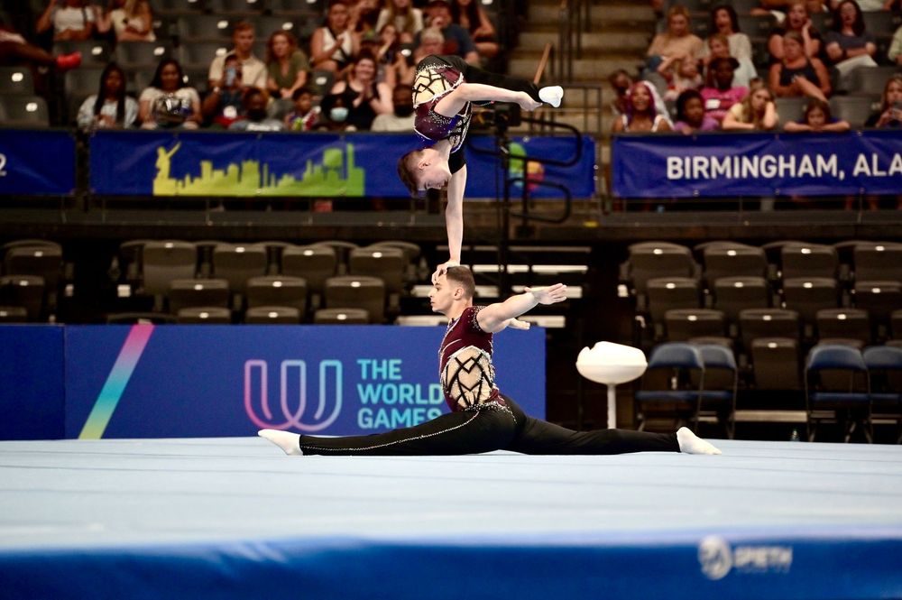 Two acrobatic gymnasts perform a balance routine at The World Games 2022 in Birmingham, Alabama.