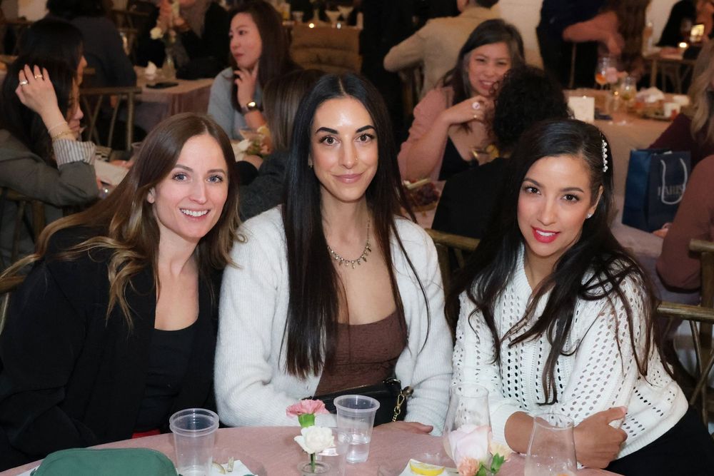 professional event photographer taking pictures of three ladies
