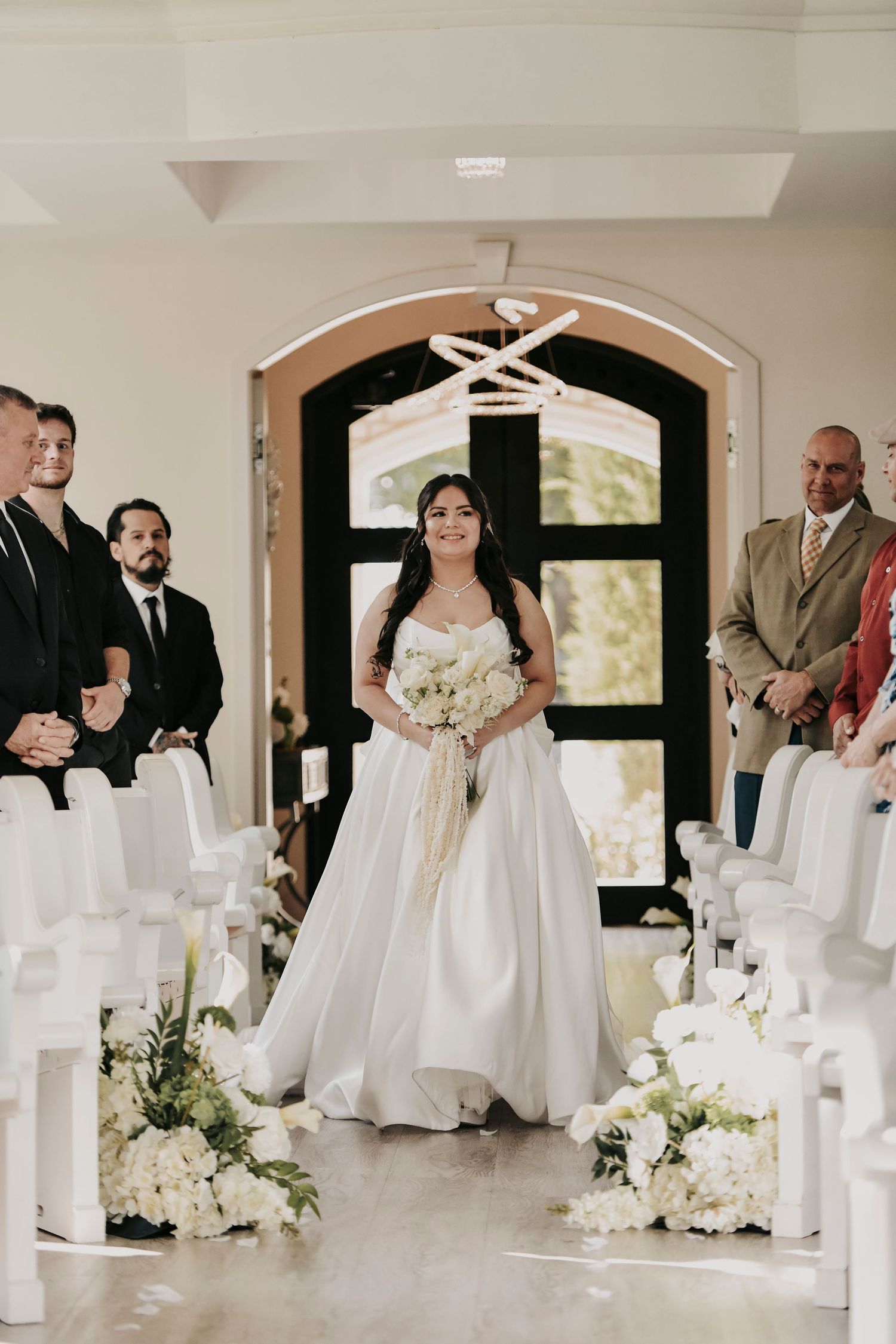 Bride walking alone down the aisle at Brighton Abbey chapel