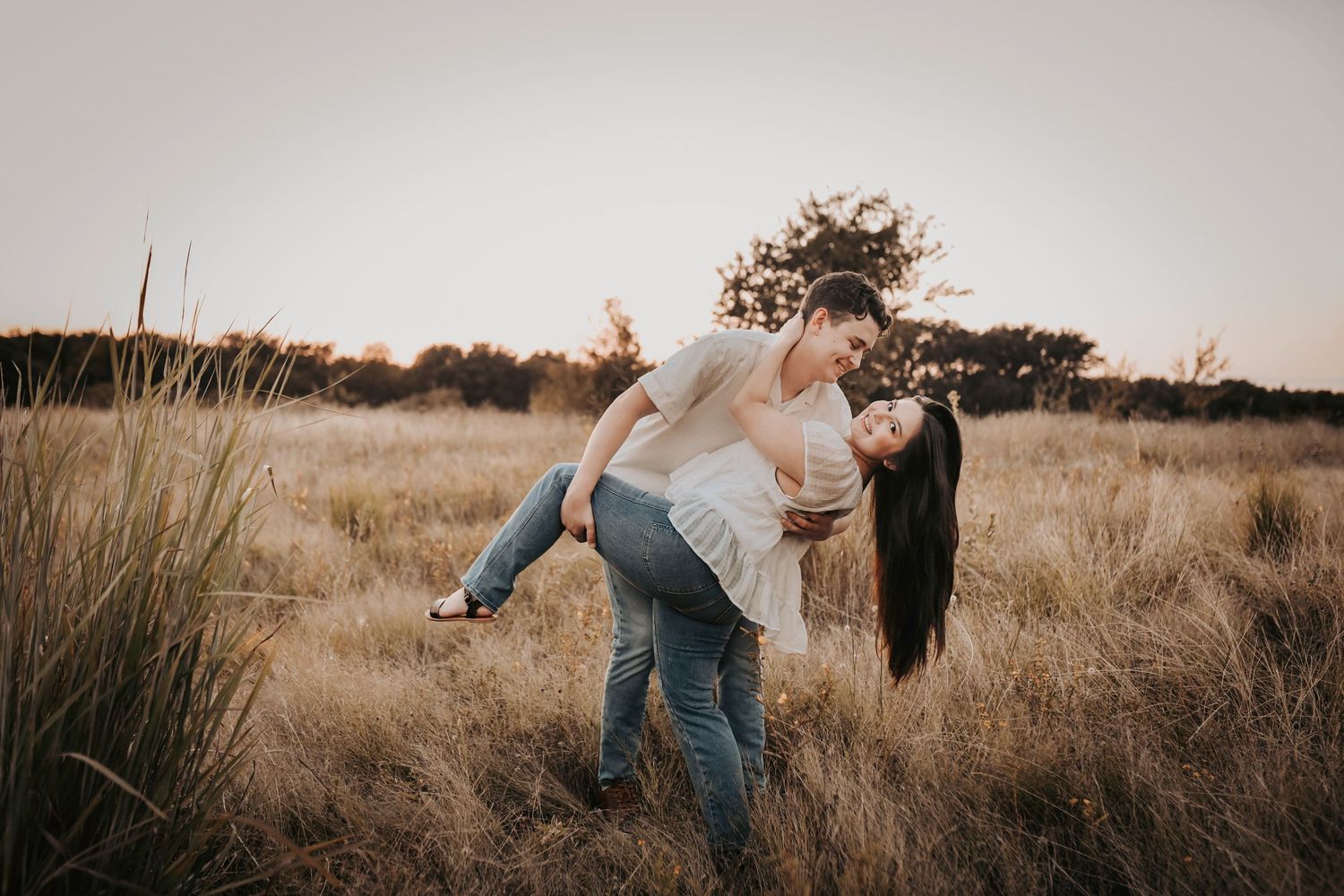 a couple dips into the golden grass at sunset at grapevine lake
