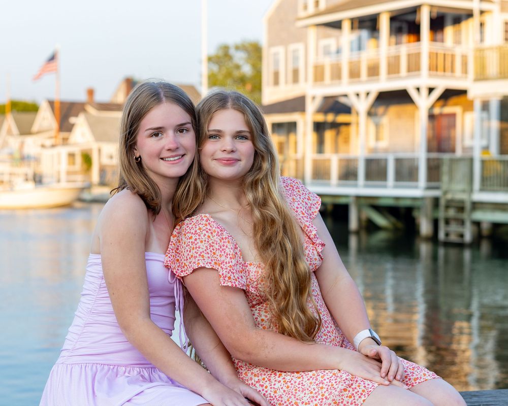 Siblings pose overlooking Old North Wharf Nantucket for high school senior yearbook portrait session.  Nantucket high school senior photos.