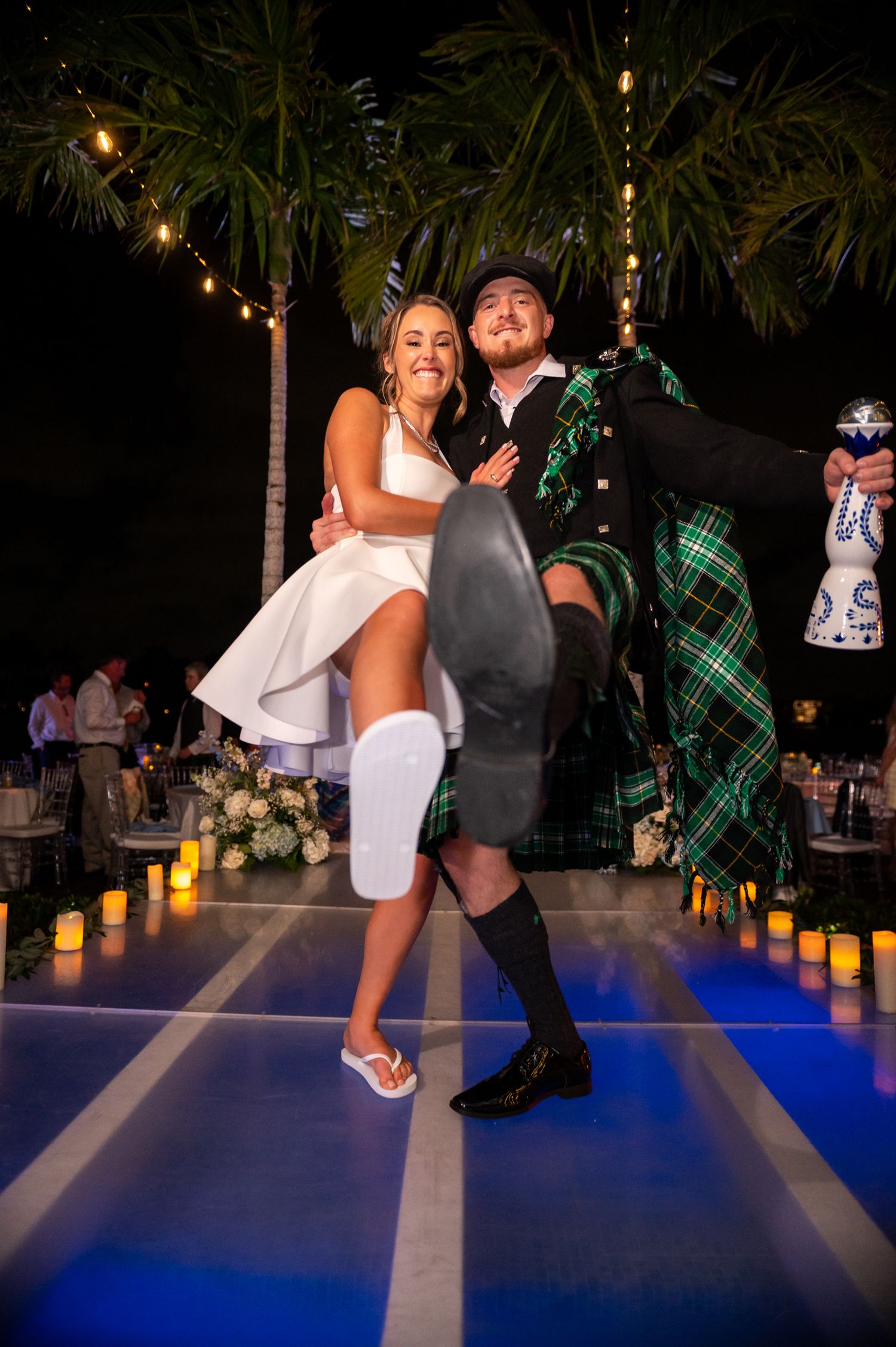 The bride and groom celebrate during their reception at their Palm Beach estate wedding.