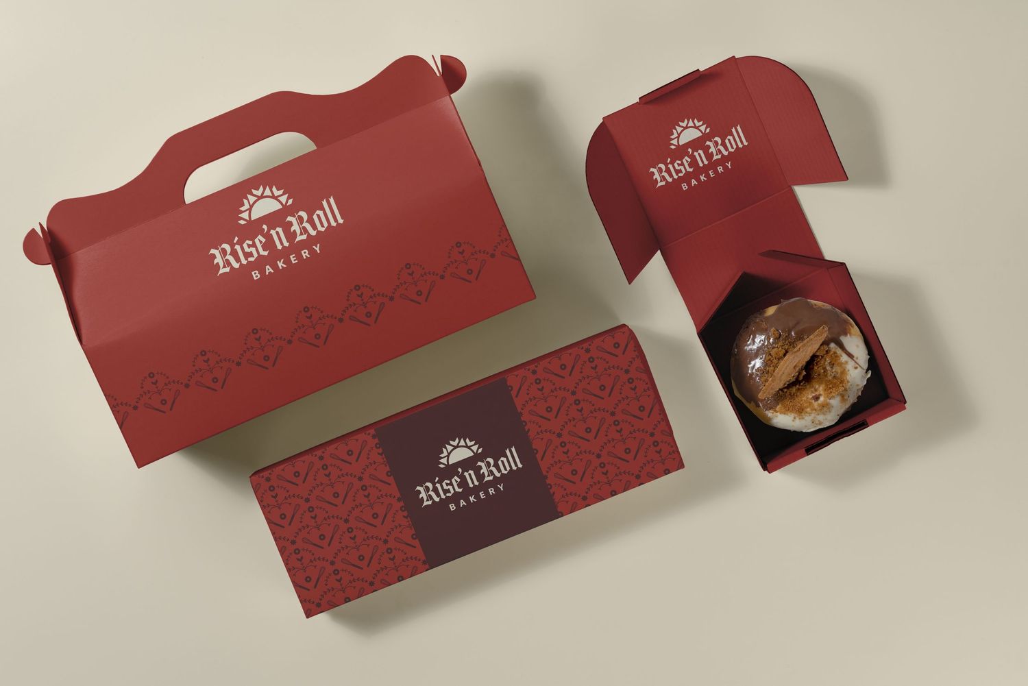 Red Rise n Roll Bakery packaging set featuring a handle box, long box, and open box displaying a pastry.