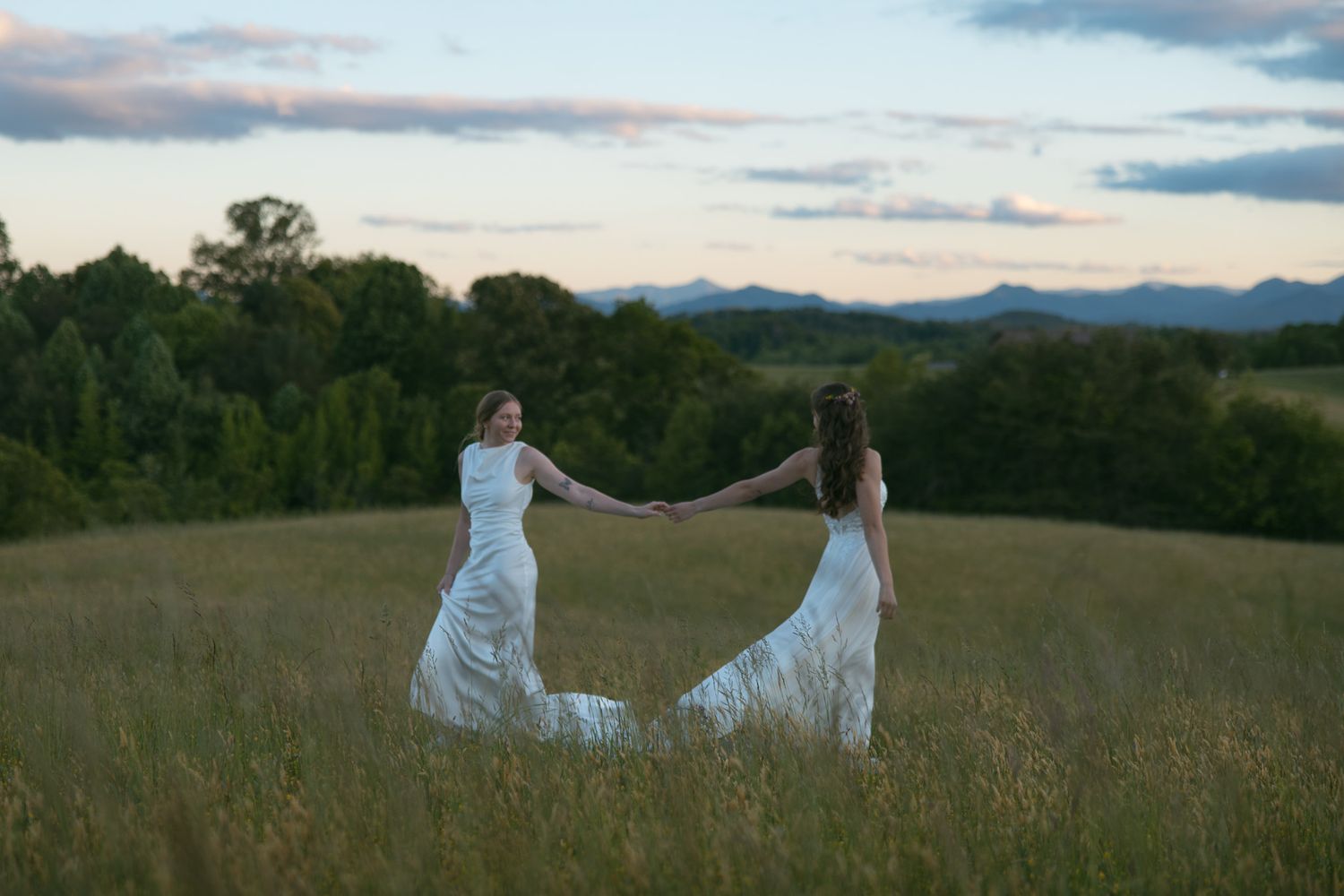 lesbian couple holding hands mountain view after wedding portraits asheville nc