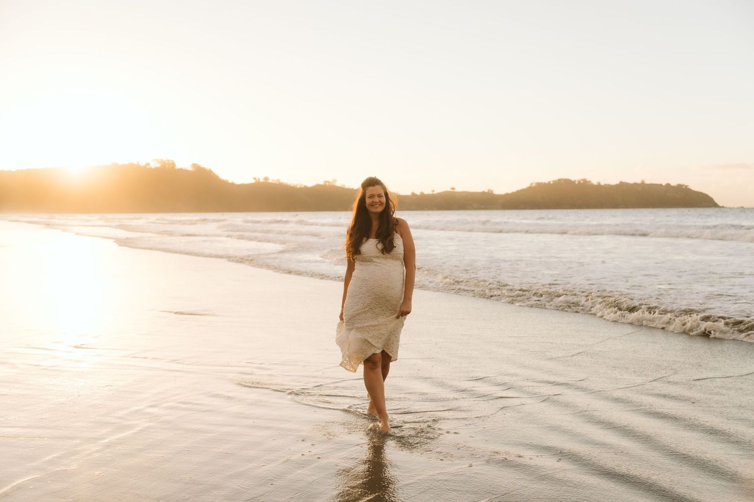 A collage of beach wedding photos showing newlyweds walking along sandy shores with turquoise ocean views.