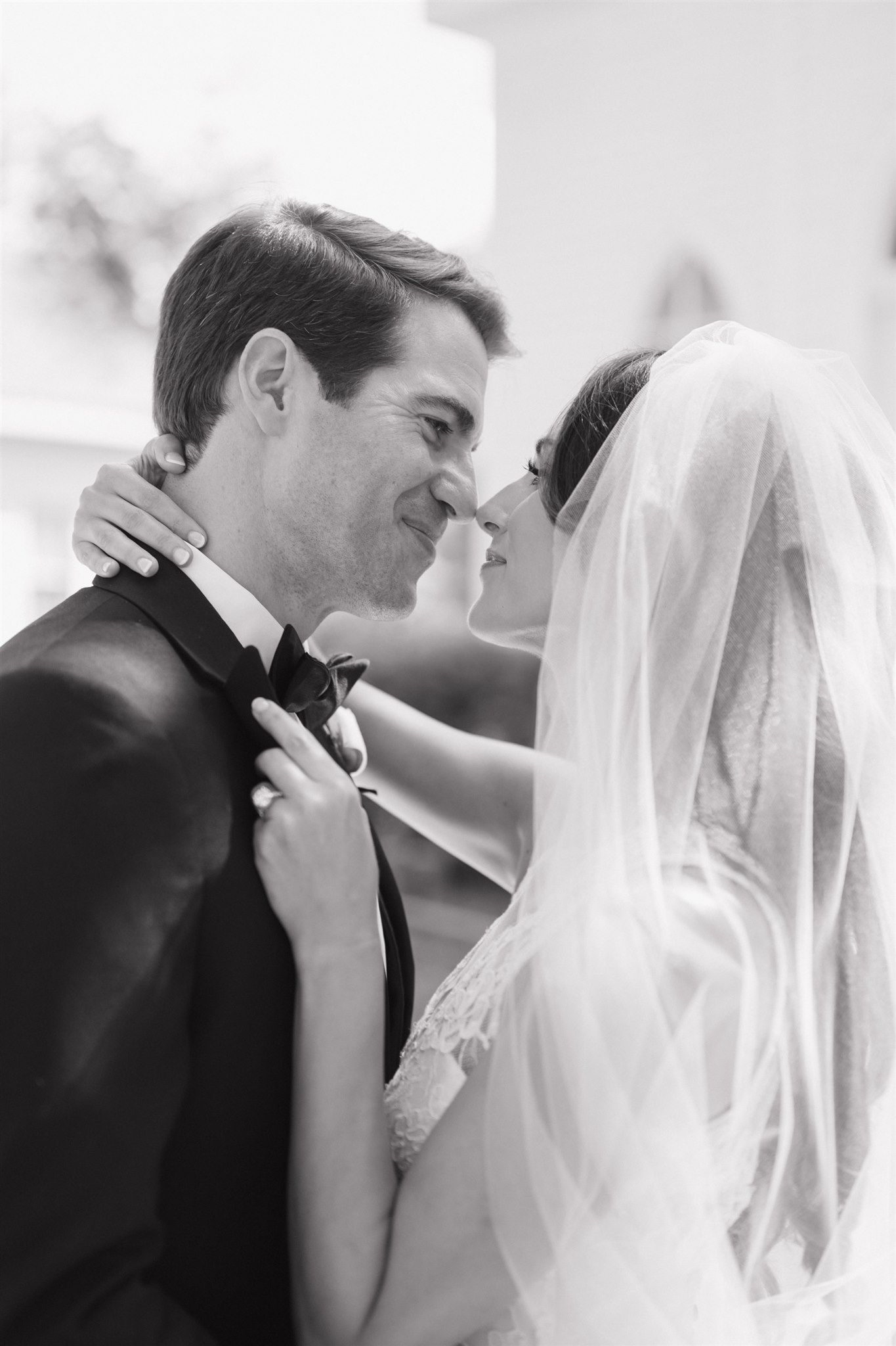 Smiling bride and groom pose together outdoors at Tomball Museum Chapel in Tomball Texas