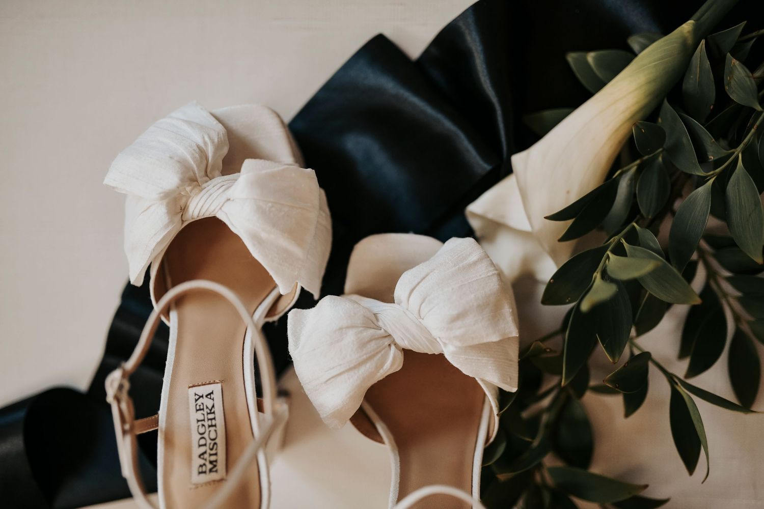fine art bridal flat lay with neutral tones, layered textures, and handwritten vows