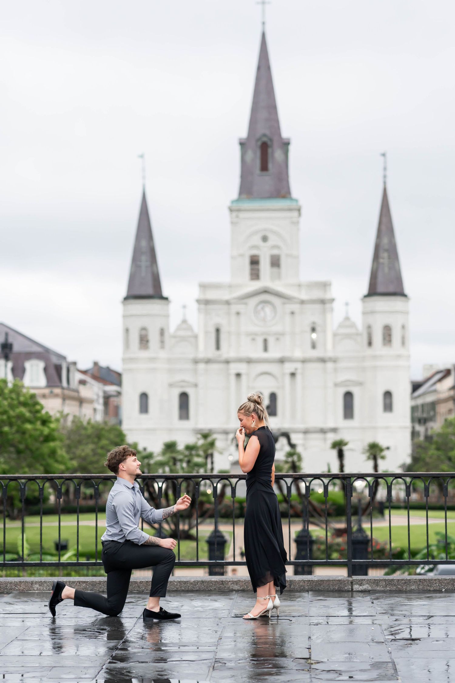 man proposes to girlfriend in front of the St. Louis Cathedral in New Orleans, LA