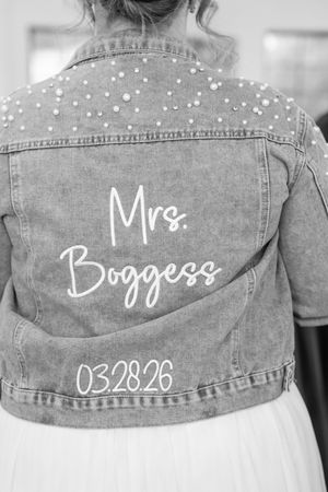 Custom pearl-embellished denim bridal jacket with Mrs. Boggess and wedding date 03.28.26 on the back.