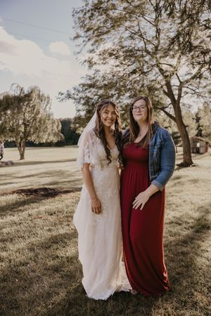bride and photographer posing for photo at an outdoor venue in Michigan