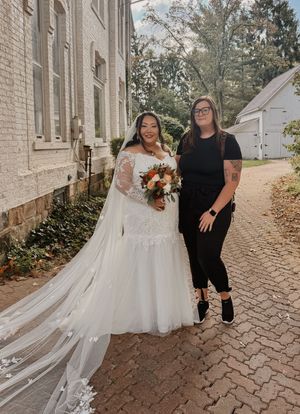 photographer posing with bride after ceremony.