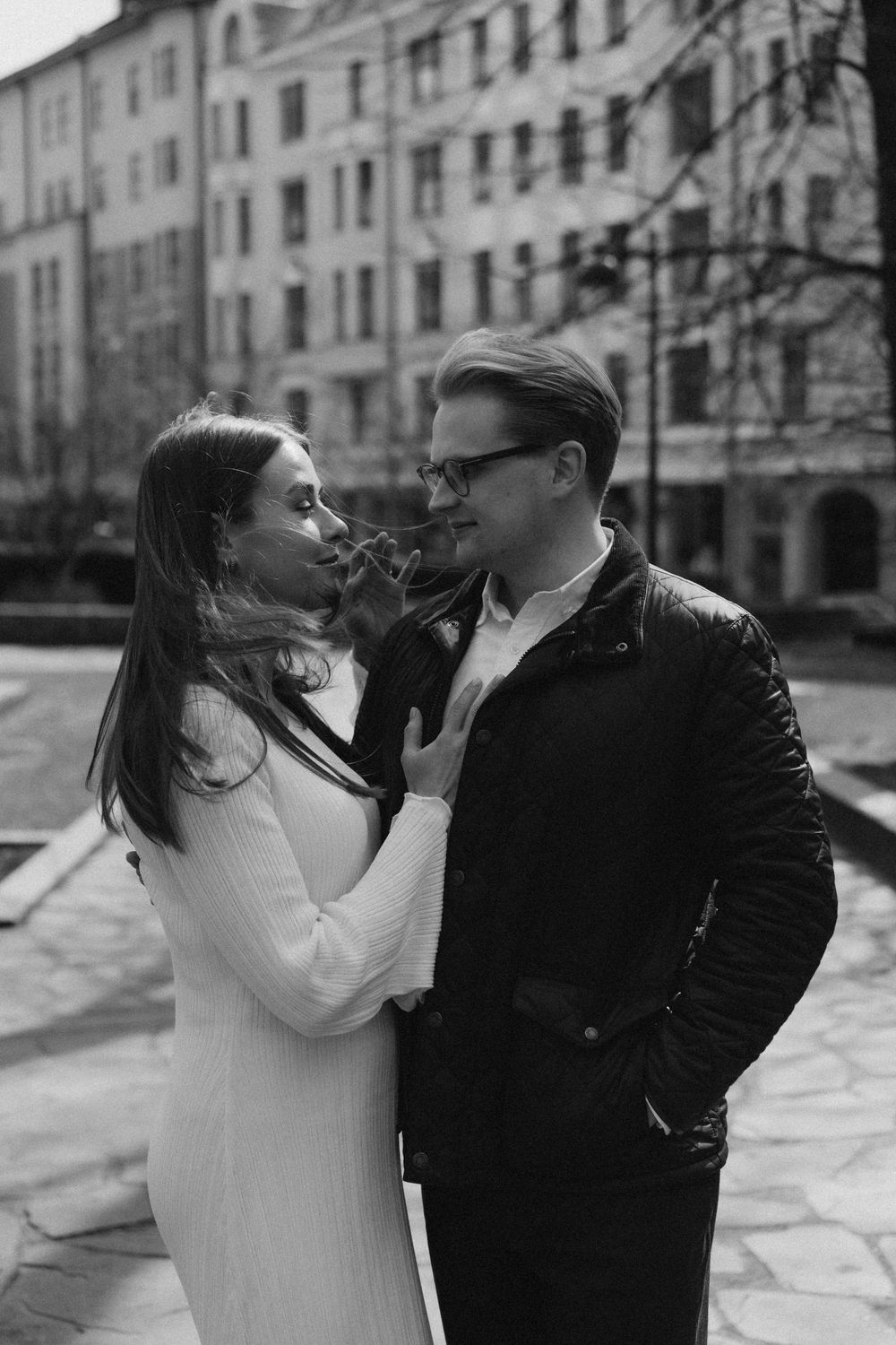 Black and white close-up engagement portrait of a couple sharing a quiet moment in Helsinki