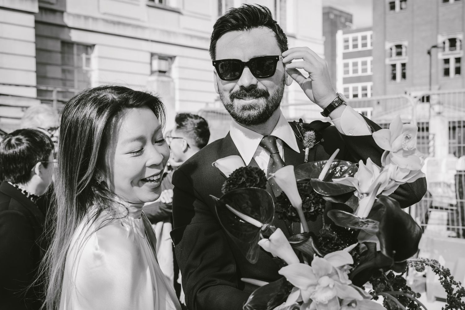 Bride and groom sitting together on a bench in an elegant Hackney Town Hall with gold lanterns, sharing an intimate moment.