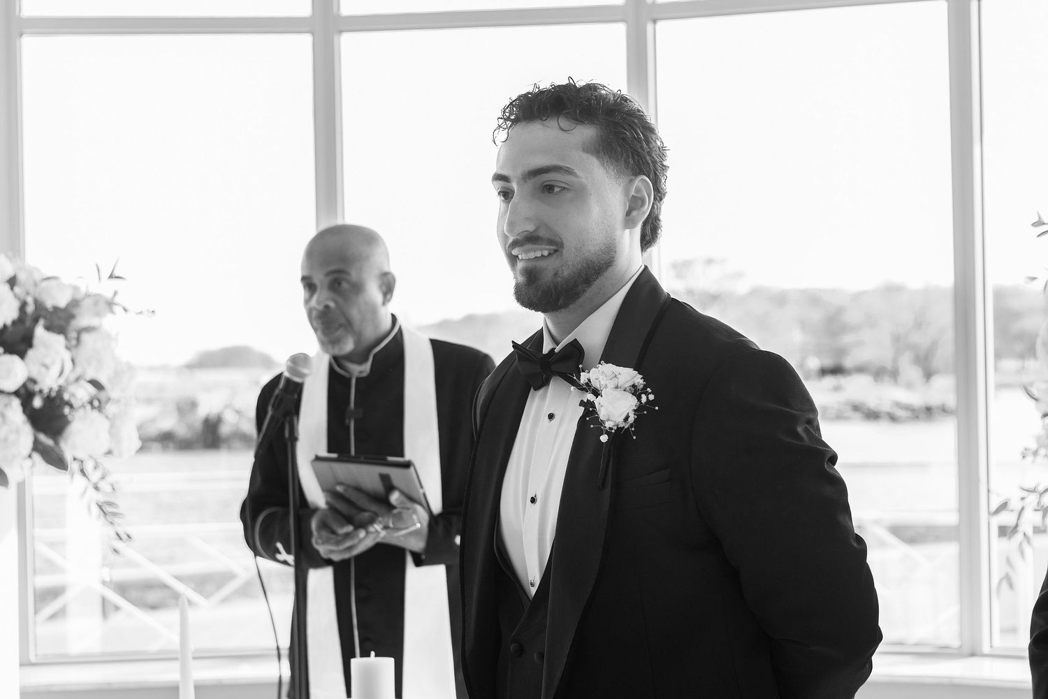 Emotional groom portrait during a waterfront wedding ceremony with natural window light in Westchester County, NY.