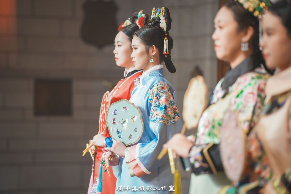 Group of elegant models showcasing beautiful Qipao dresses at a cathedral fashion event, by an Auckland photographer.Group of elegant models