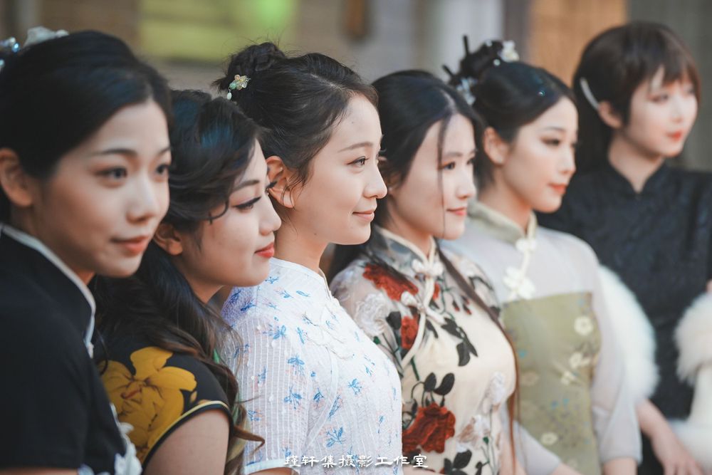 Group of elegant models showcasing beautiful Qipao dresses at a cathedral fashion event, by an Auckland photographer.