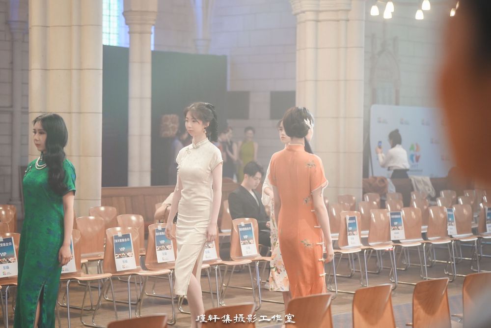Group of elegant models showcasing beautiful Qipao dresses at a cathedral fashion event, by an Auckland photographer.