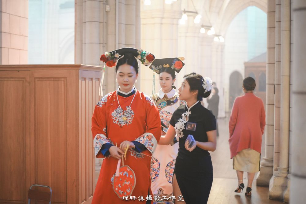 Group of elegant models showcasing beautiful Qipao dresses at a cathedral fashion event, by an Auckland photographer.