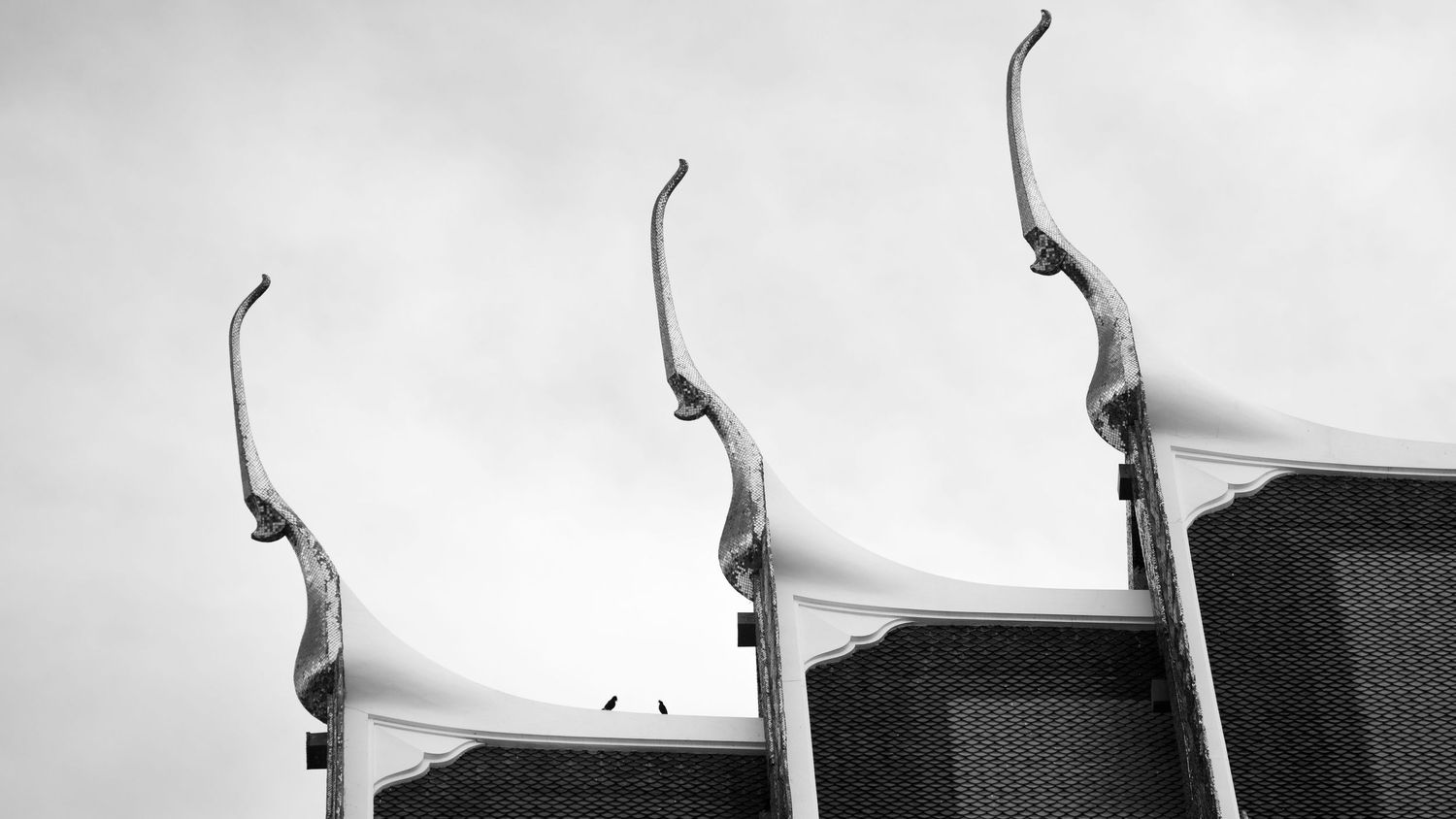 Abstract black and white architectural shapes against a light background.