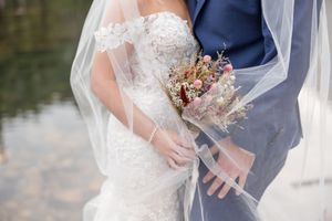 Newlywed couple embraces in romantic poses during outdoor wedding photo session.