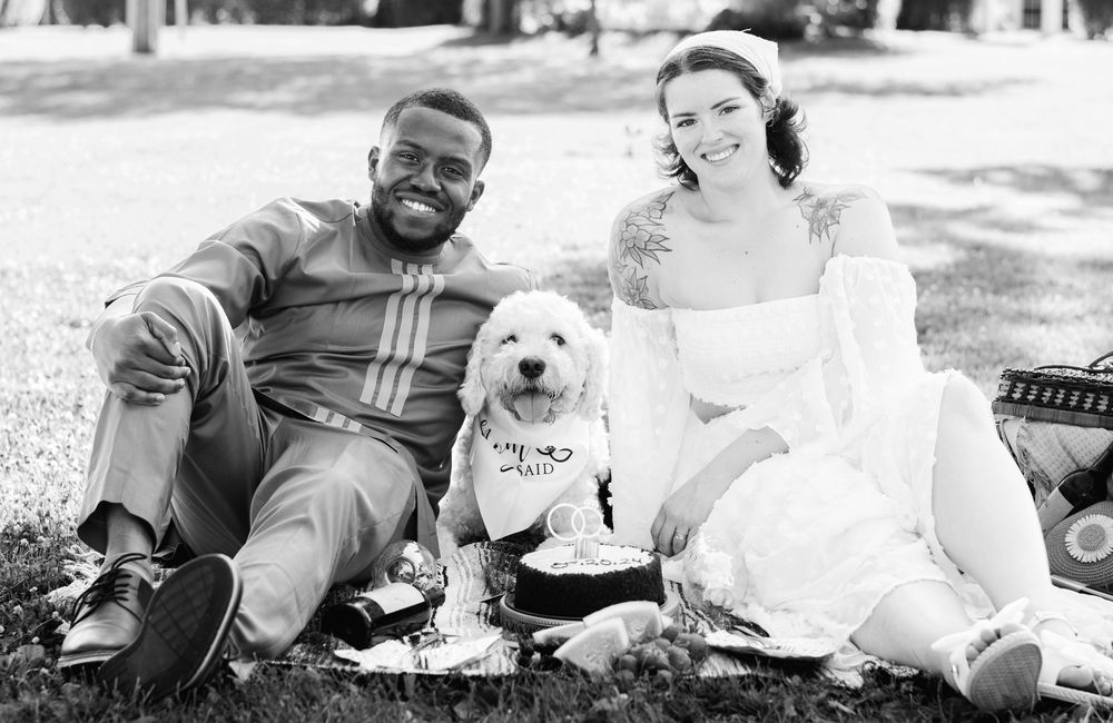 Black and white wedding photos featuring a couple with their small white dog.