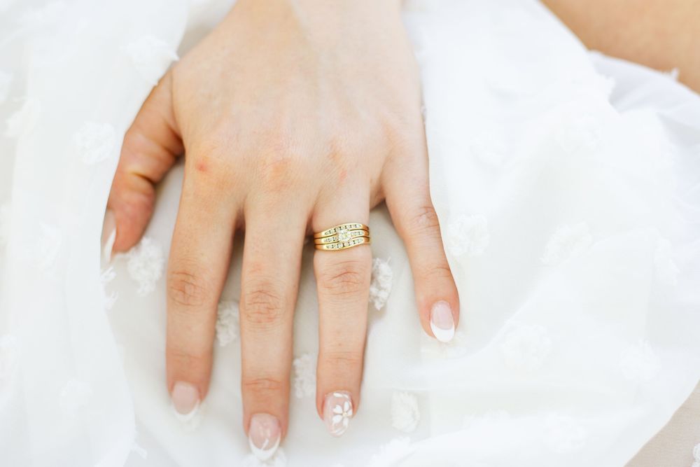 Close-up shots of wedding rings and bridal manicure details.