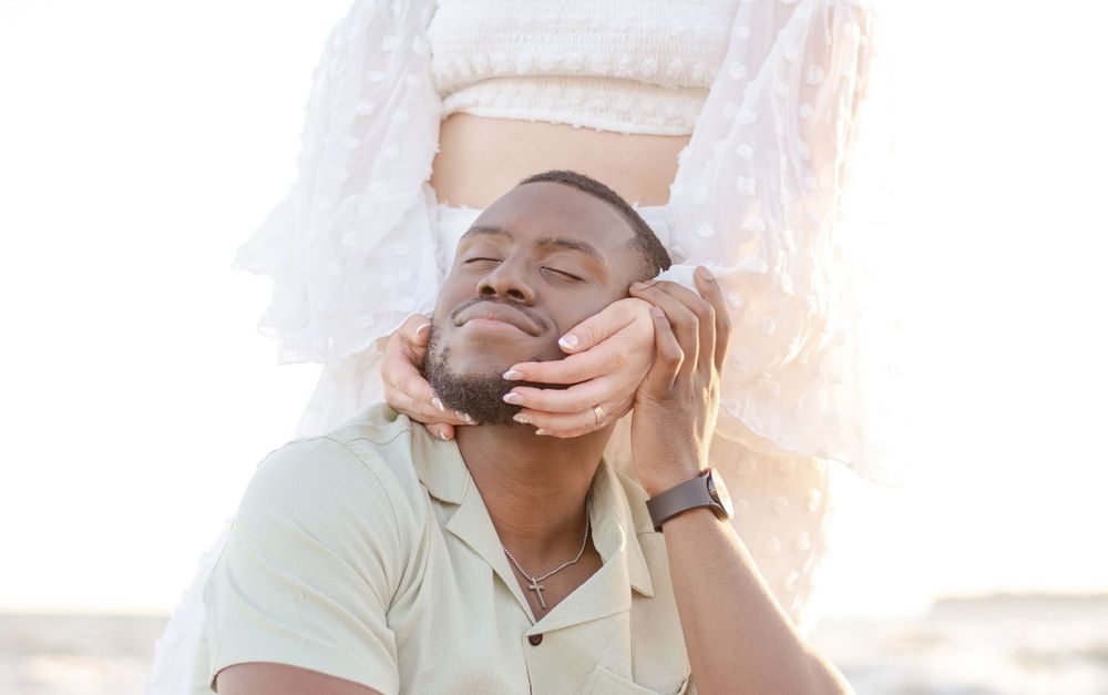 Close-up shot of a couple sharing an intimate moment outdoors.