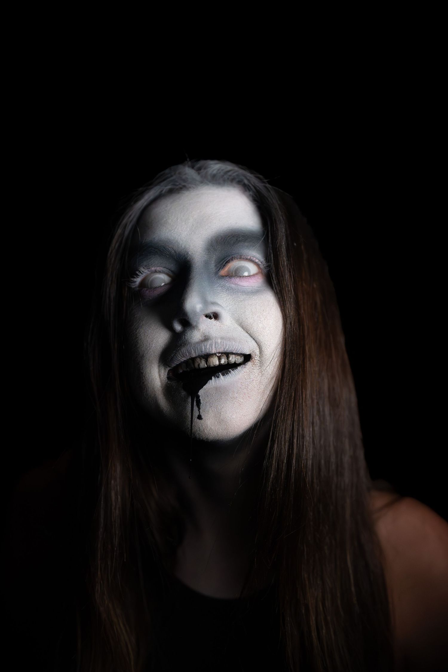 Creepy ghost with black liquid coming out of its mouth.