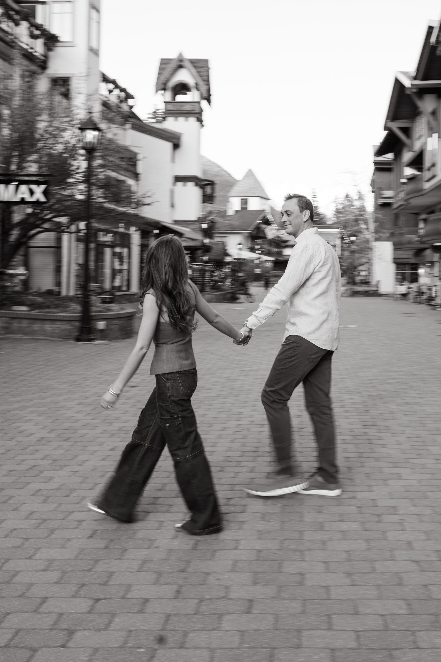 guy and girl walking down vail village