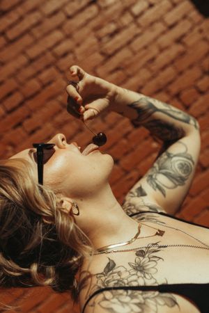 Side view showing tattoos and profile in artistic photo series against textured background.