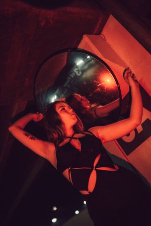 A series of moody red-lit photos showing dramatic poses against a dark background.